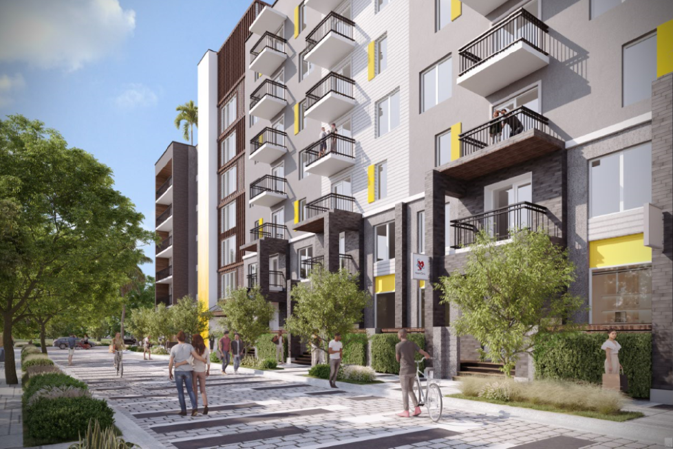 A modern apartment complex with balconies and a pedestrian walkway in front.